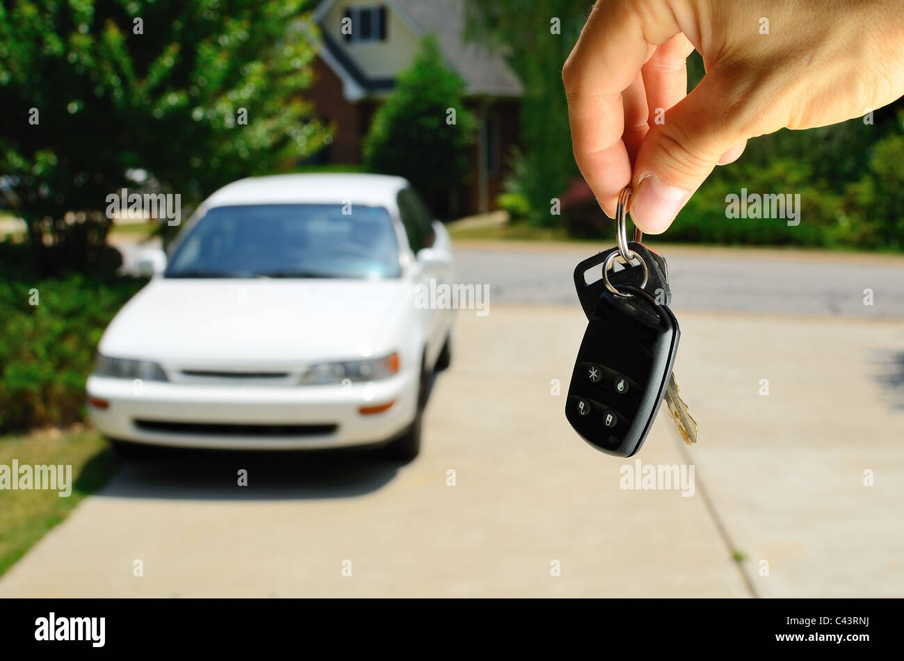 Handing over the keys to a used car. Stock Photo