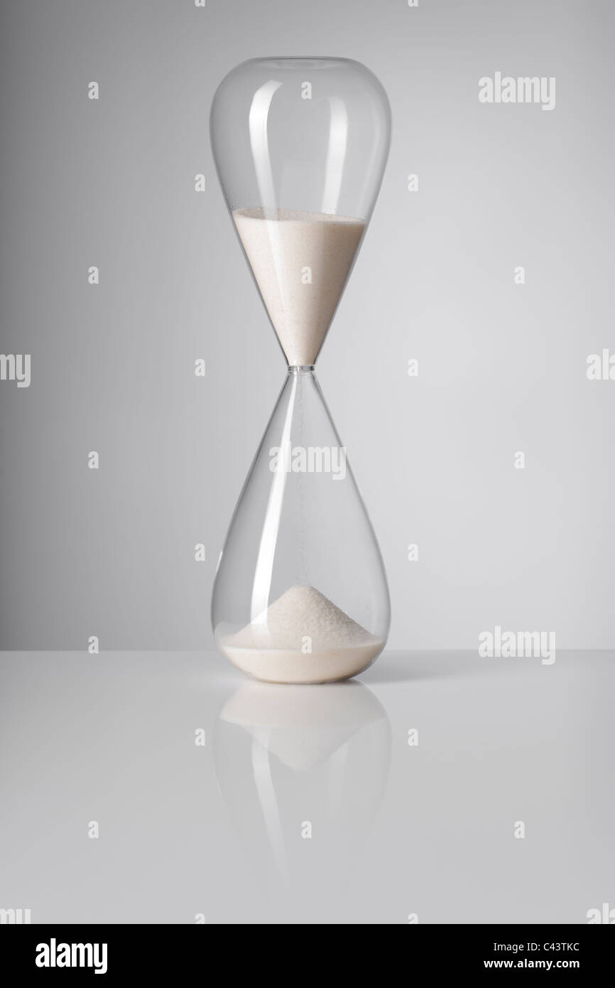 A Hourglass on reflective background. Stock Photo