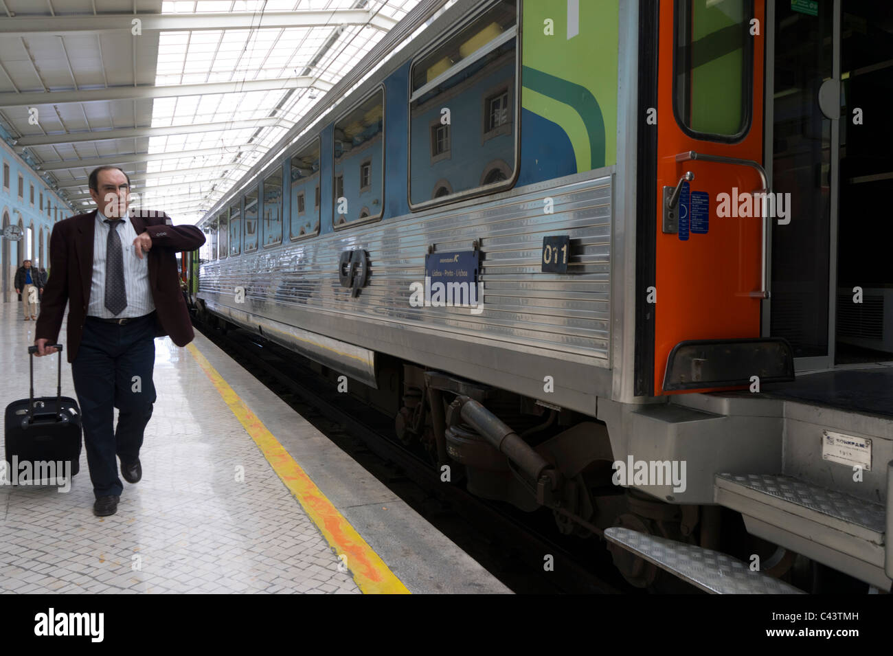 Passenger with suitcase next to an intercity train in Santa Apolónia railway station in Lisbon, Portugal, Europe Stock Photo