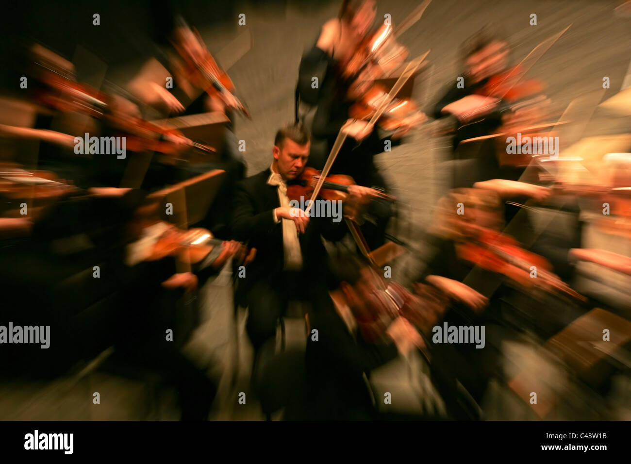 Man playing violin during a symphony orchestra classical music concert Stock Photo