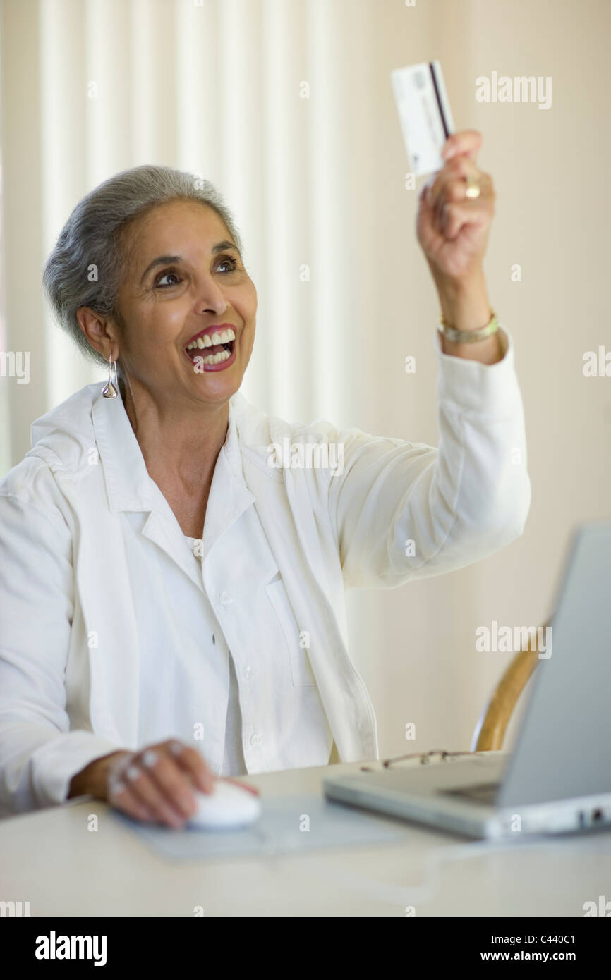 African American woman shopping online with credit card and laptop computer Stock Photo