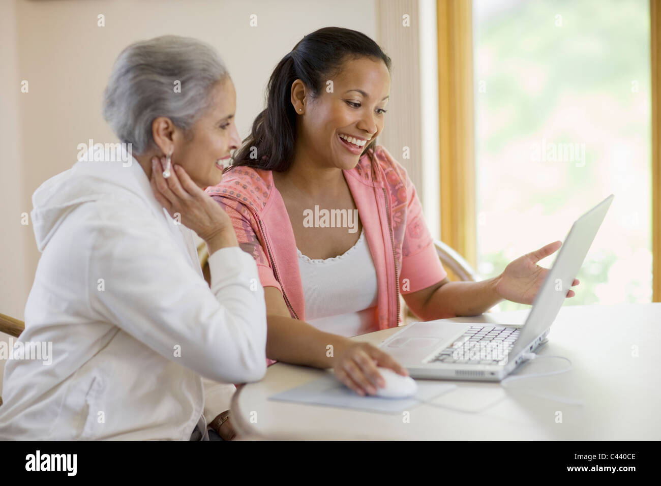 Attractive black mother and daughter using computer Stock Photo