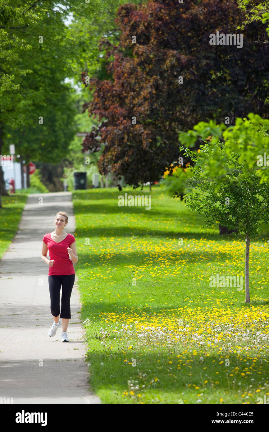 Pretty woman walking in the neighborhood Stock Photo
