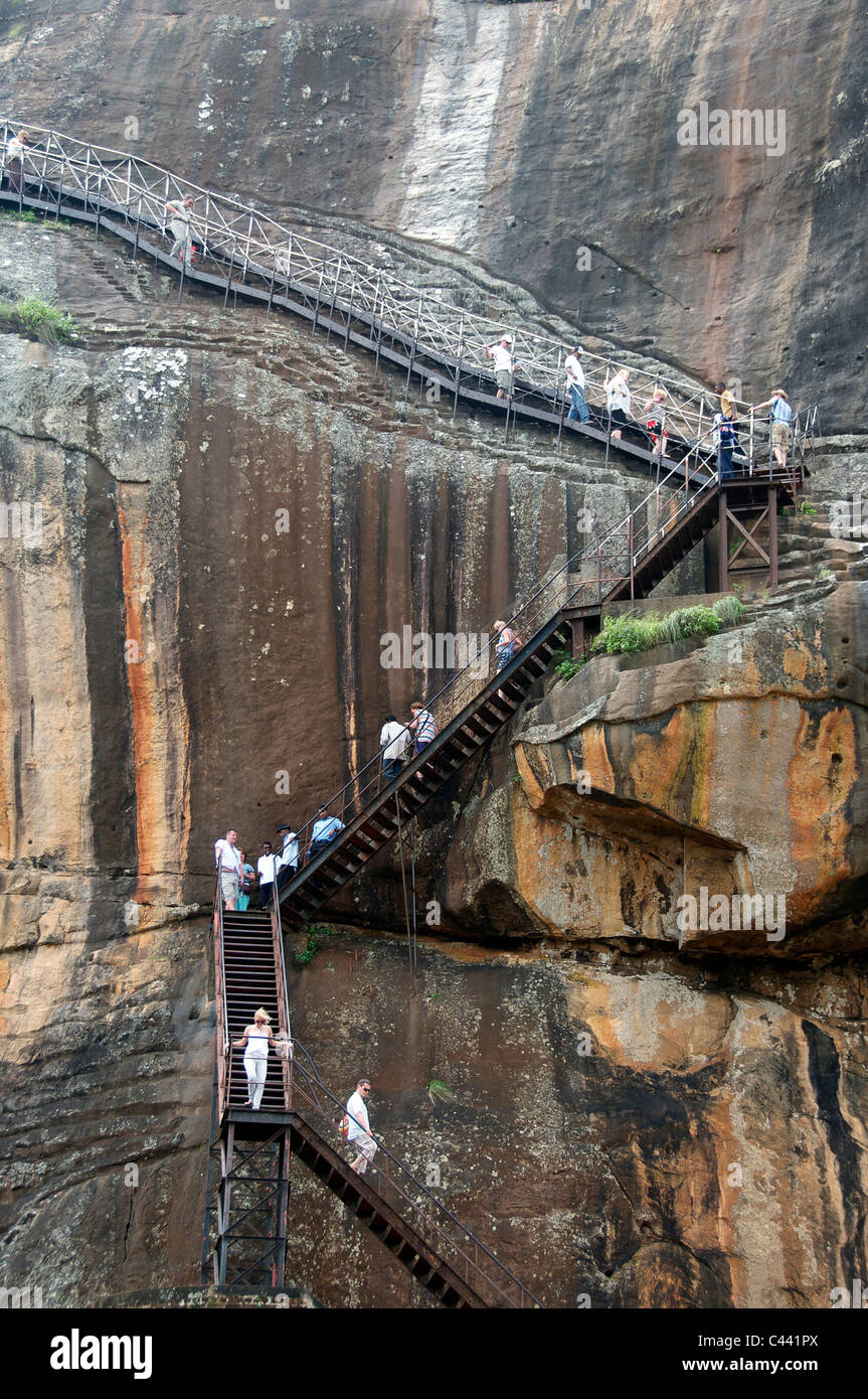 Visitors on staircase to summit of Sigiriya Rock Fortress Sri Lanka Stock Photo