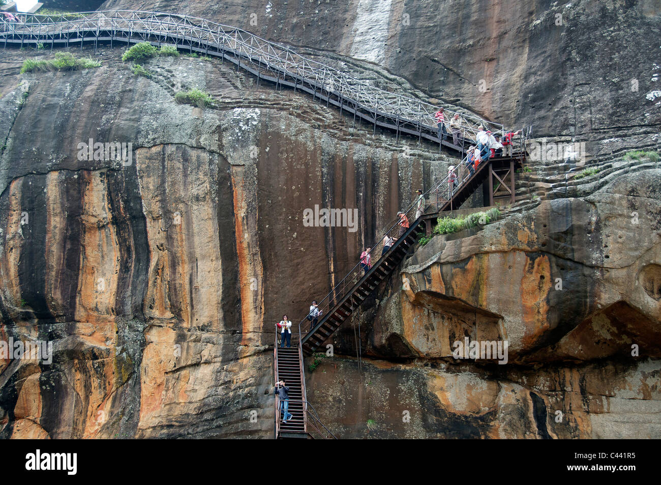 Visitors on staircase to summit of Sigiriya Rock Fortress Sri Lanka Stock Photo