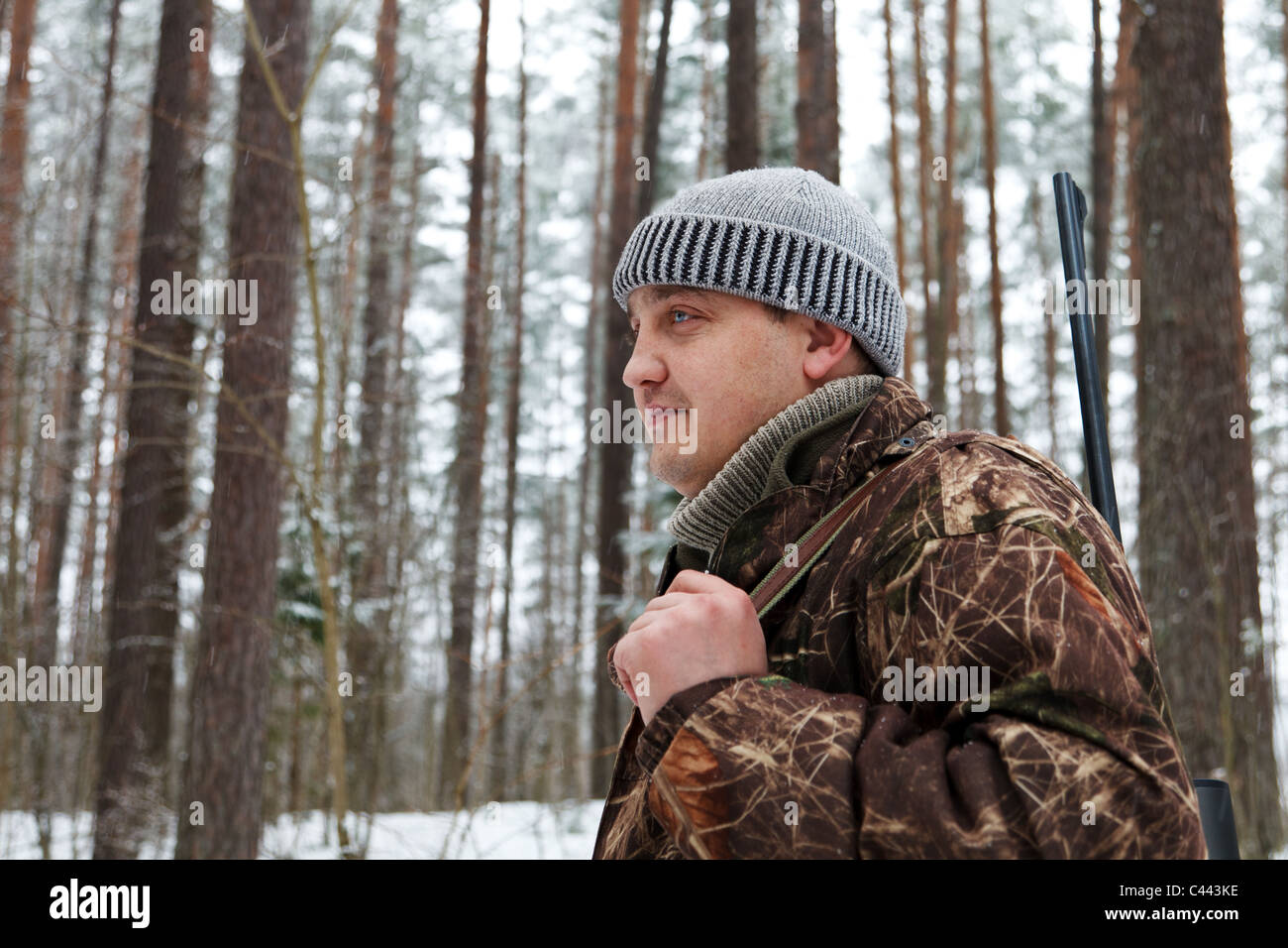 Hunter portrait at winter forest. Stock Photo
