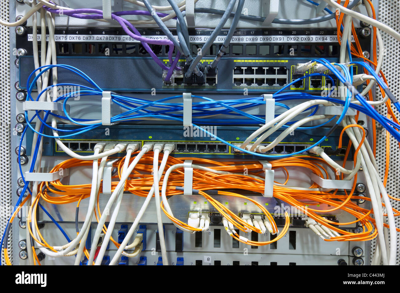foreground of a network hub and patch cables Stock Photo Alamy