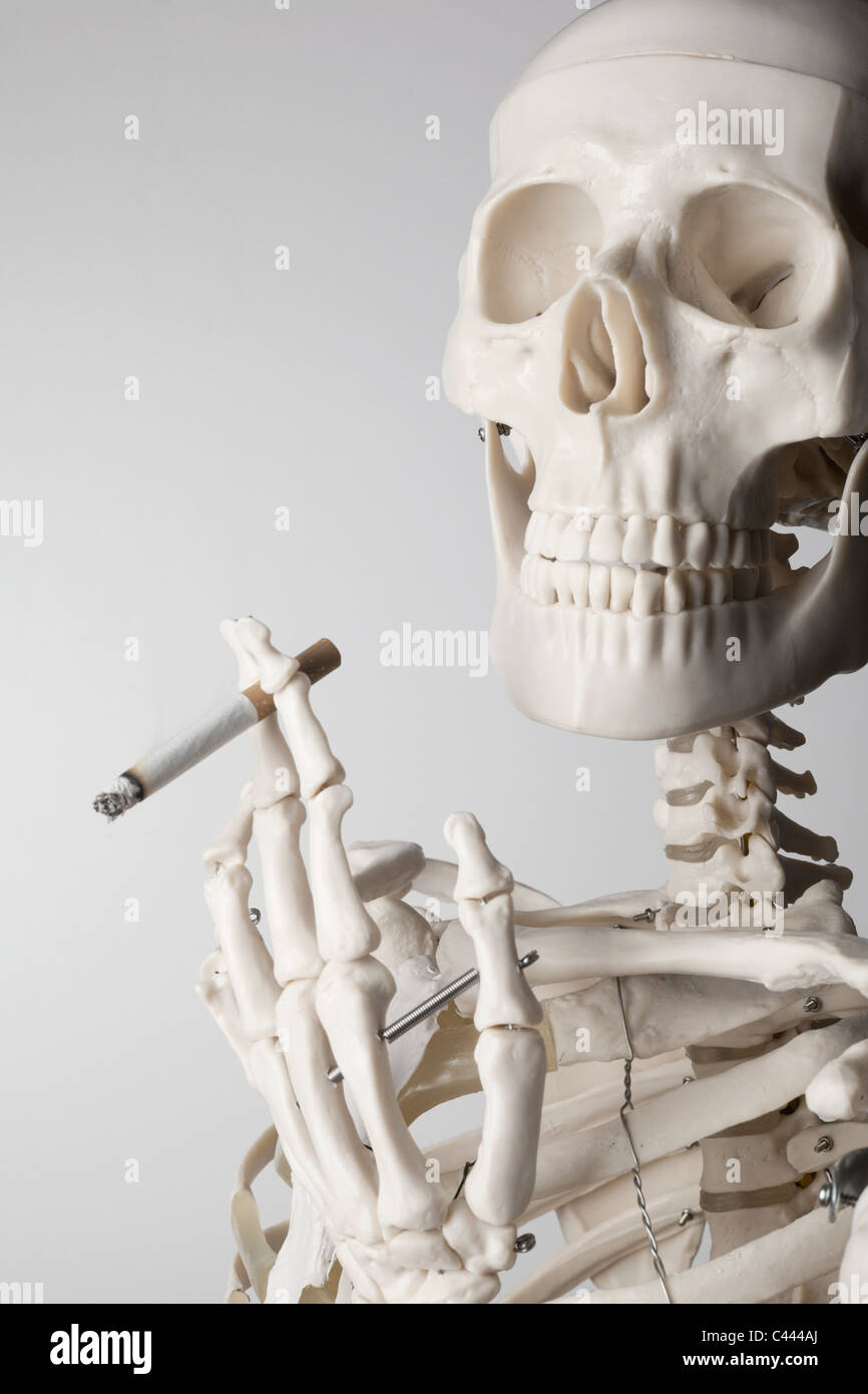A skeleton smoking a cigarette Stock Photo