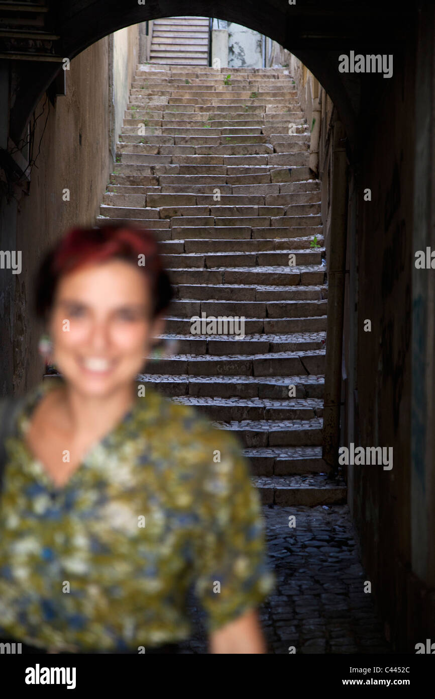 A woman in an alley, focus on background Stock Photo