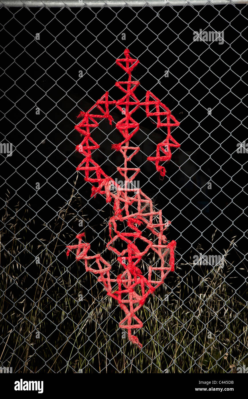Dollar sign design on a chain link fence Stock Photo