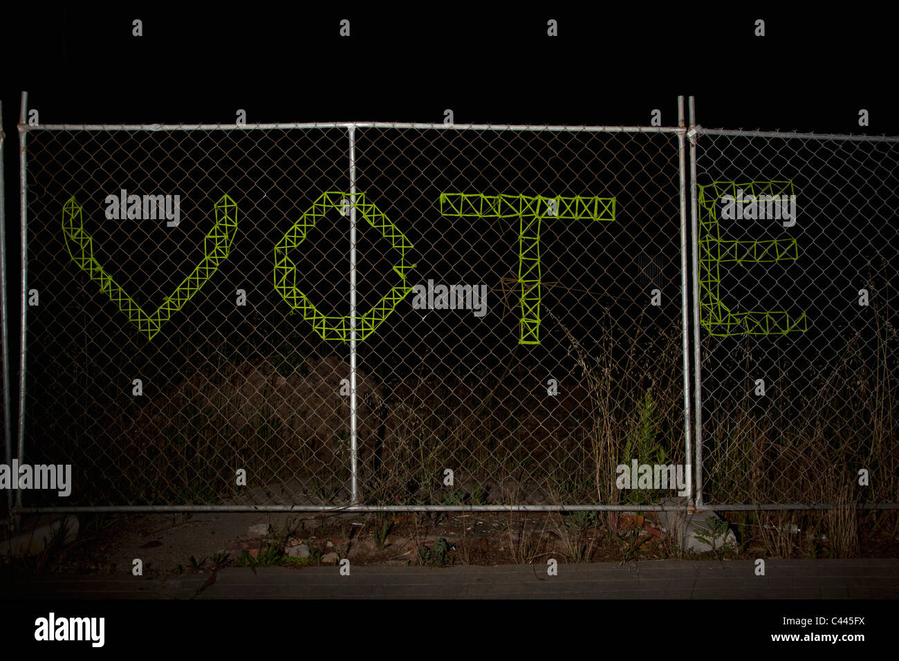 VOTE spelt on a chain link fence Stock Photo