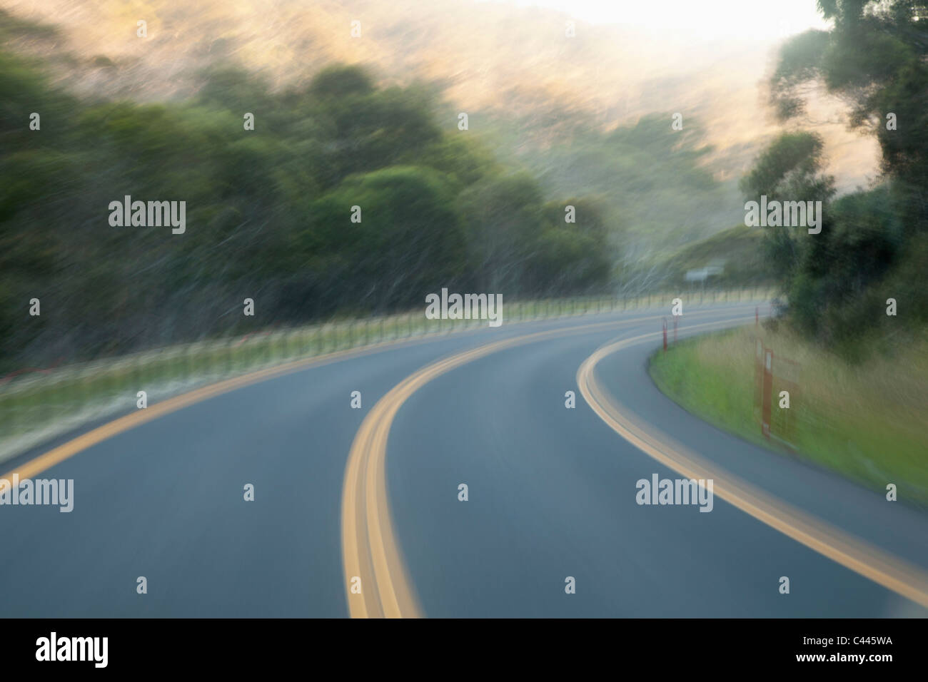 A curve in a highway road, blurred motion Stock Photo