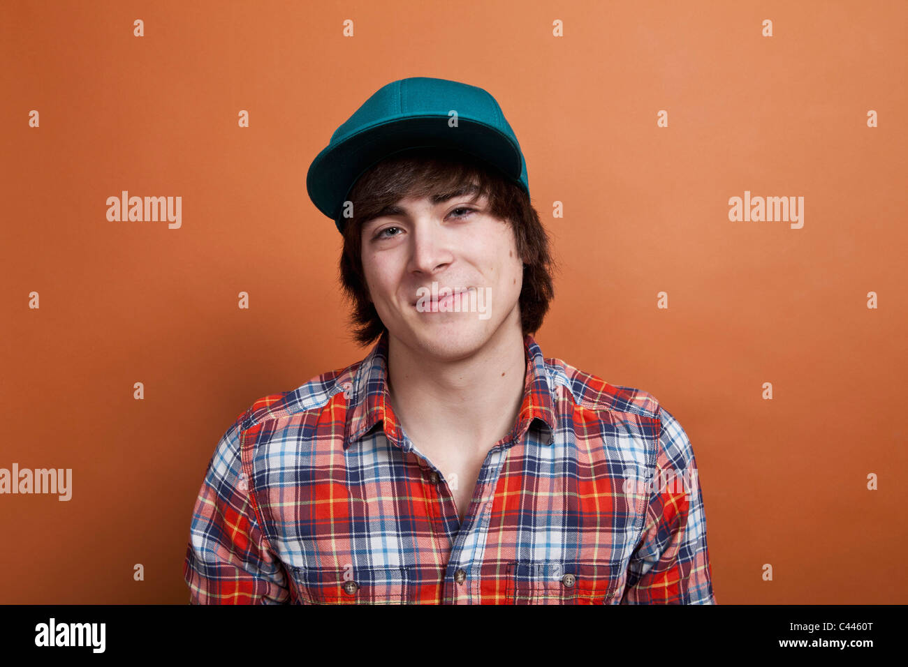 A teenage boy smiling, portrait, studio shot Stock Photo