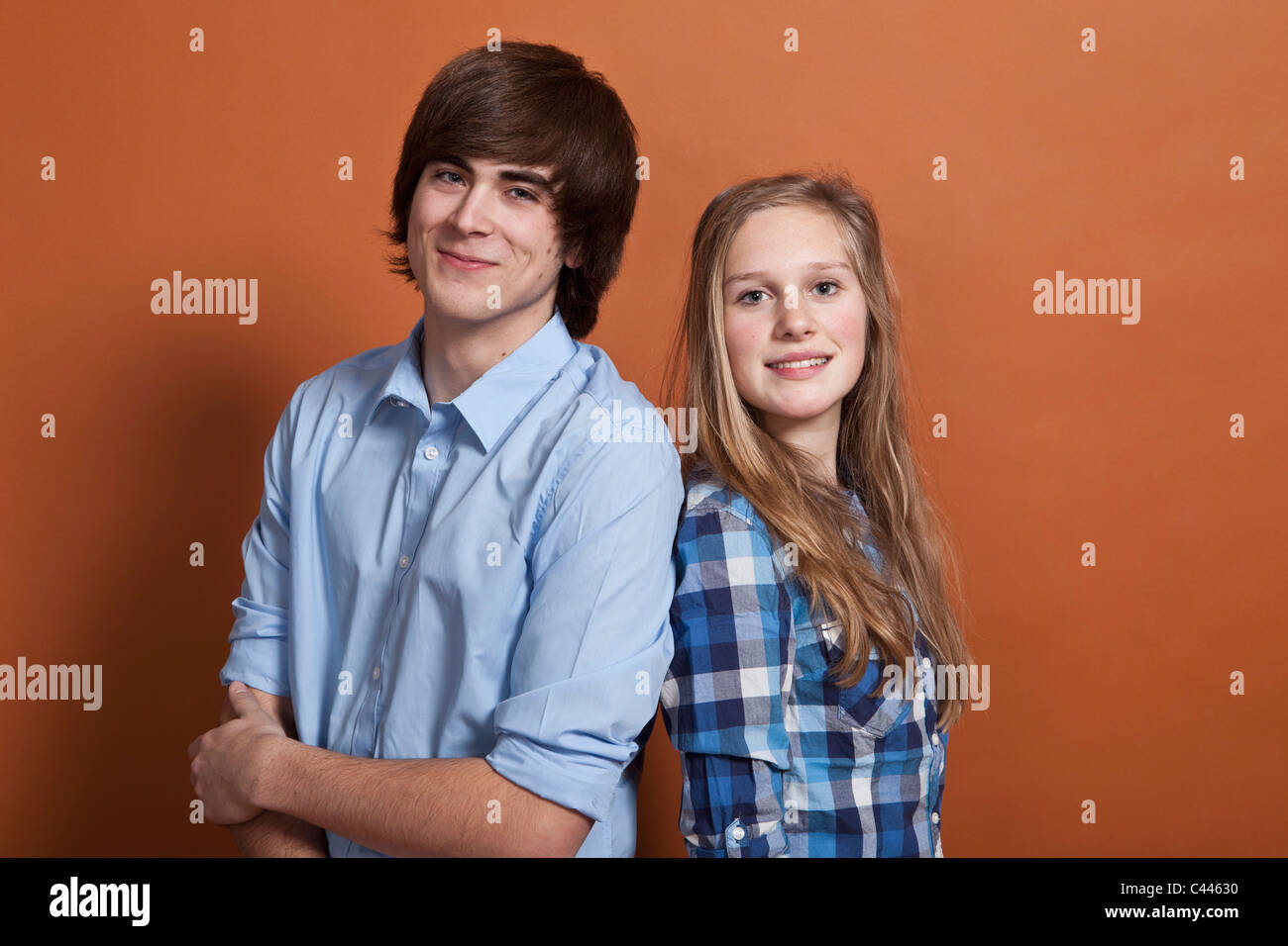 A teenage boy and girl, portrait, studio shot Stock Photo