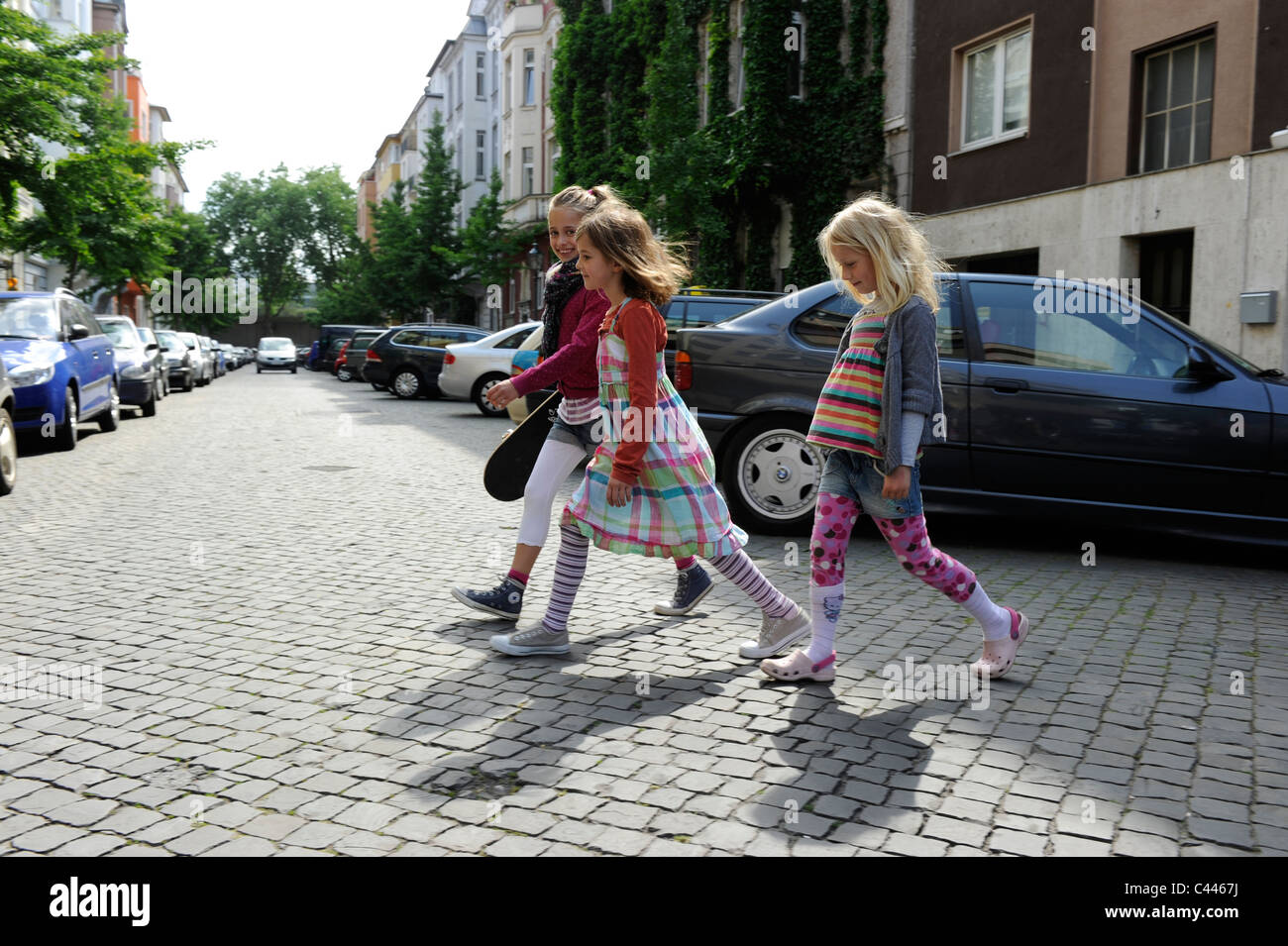 Children five to nine, playing in the city on a residential road in Duesseldorf, Germany. Stock Photo