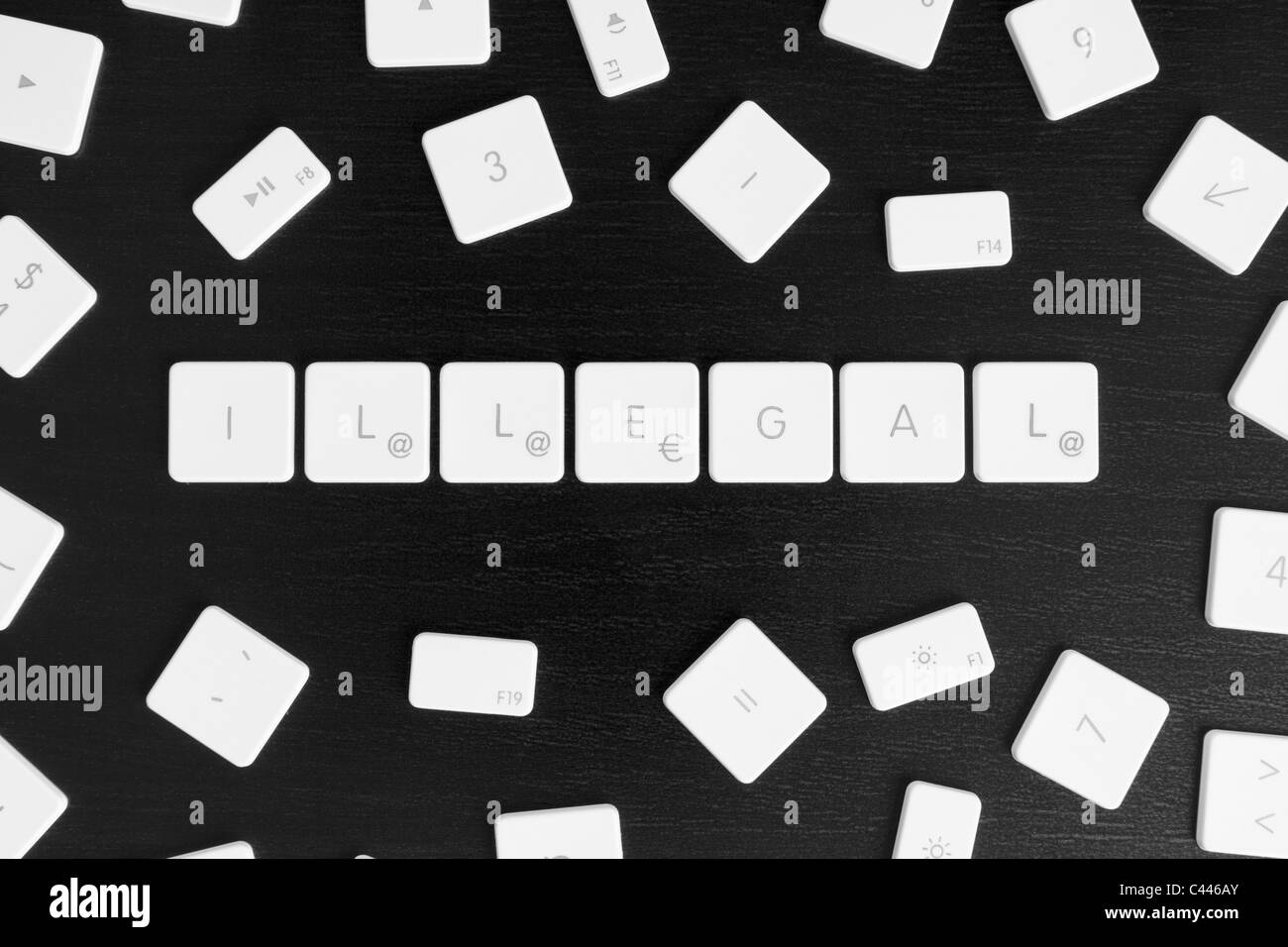 Computer keys spelling the word ILLEGAL Stock Photo