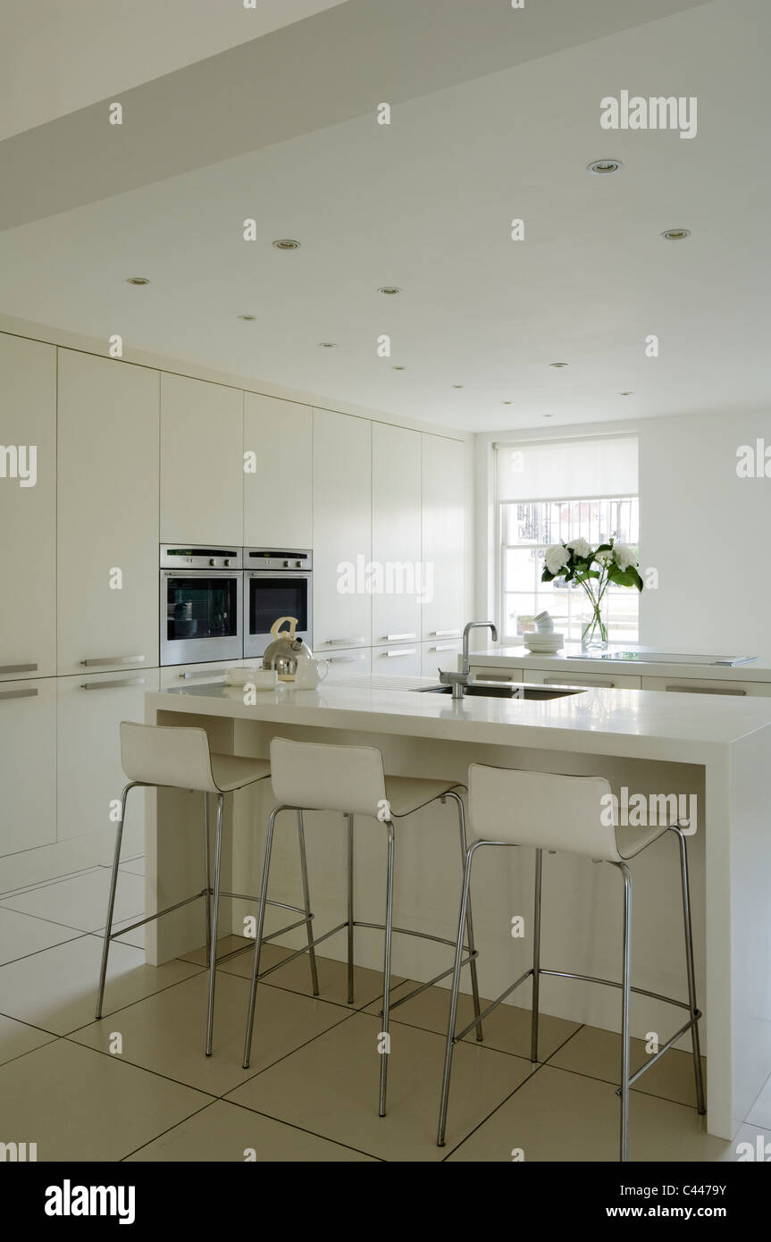 White Contemporary Kitchen With Corian Worktops Barstools And