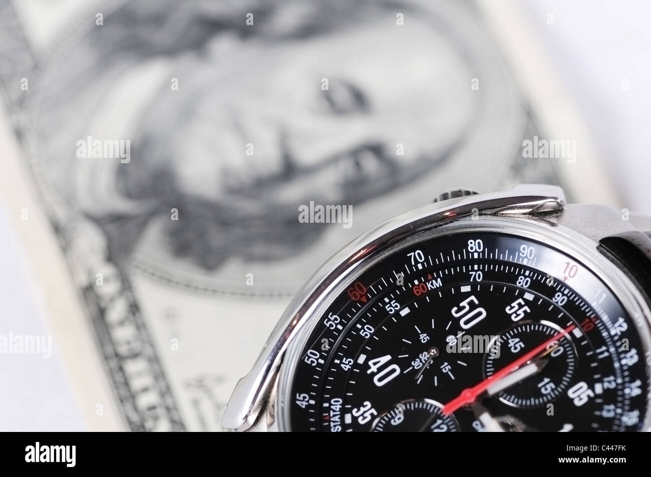 Photo of wrist watch shoot close up against hundred dollars Stock Photo