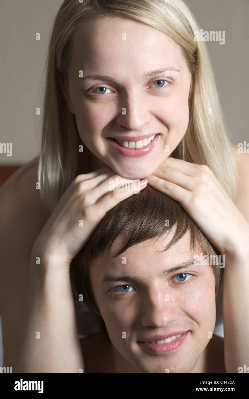 A woman resting her chin on top of her boyfriend's head, portrait Stock Photo