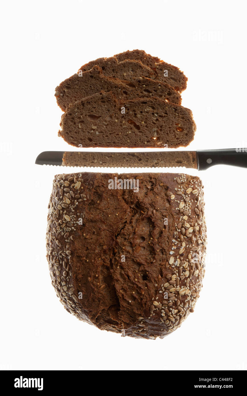 A loaf of bread, sliced with a bread knife Stock Photo