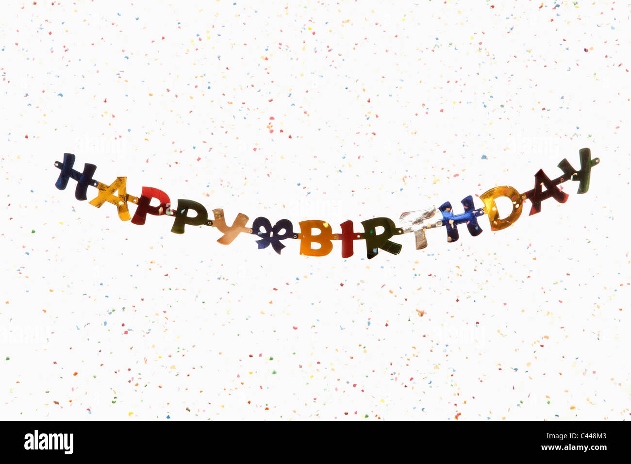 A hanging banner spelling HAPPY BIRTHDAY with confetti Stock Photo