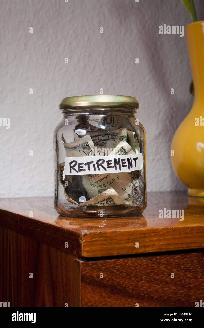 Money in a jar labeled RETIREMENT Stock Photo
