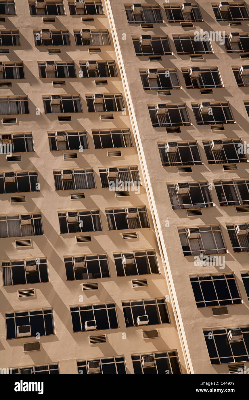 Tower block of flats with air conditioners on each window Stock Photo