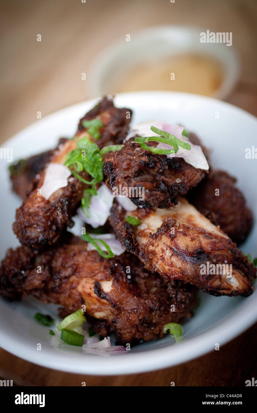 A dish of Chinese sticky pork ribs served with rice noodles and sweet