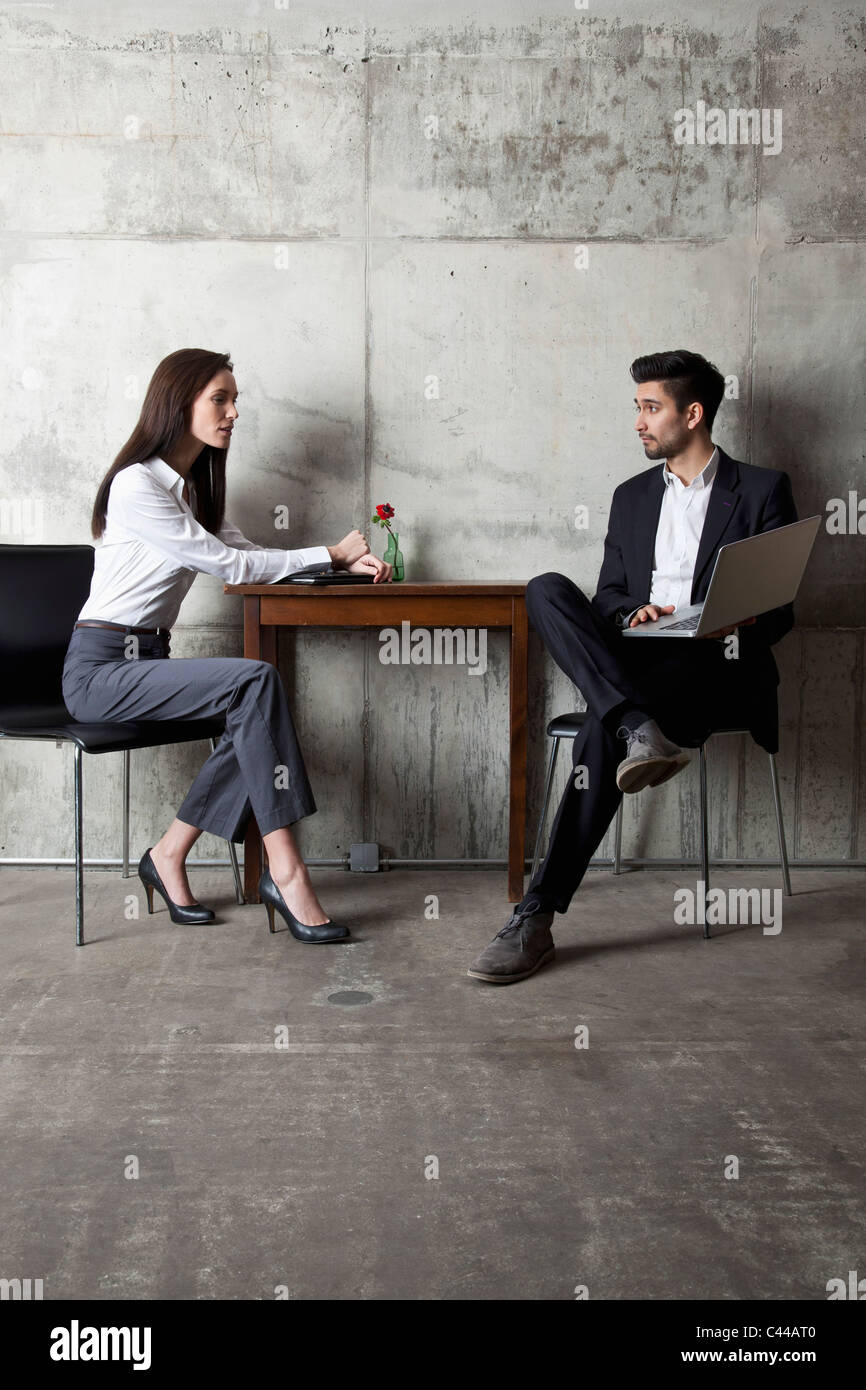 A businessman and businesswoman having a meeting in a modern office ...