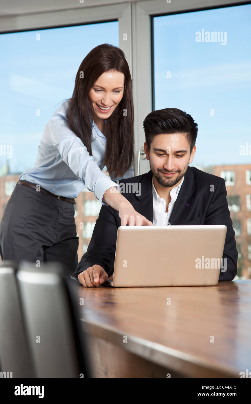 A businessman and businesswoman having a meeting in a board room Stock ...
