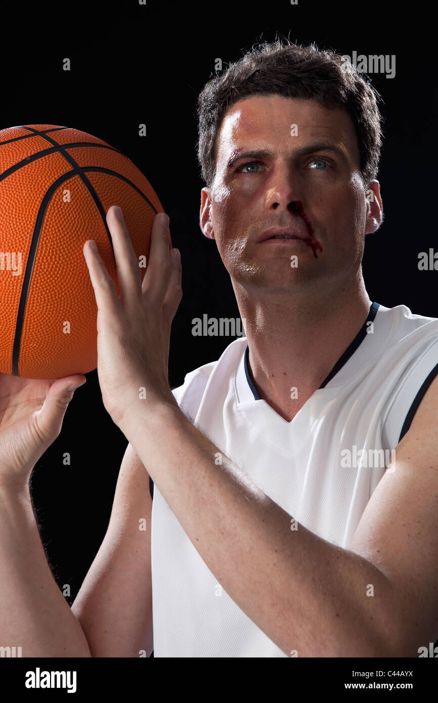 A bruised basketball player preparing to shoot a basket Stock Photo