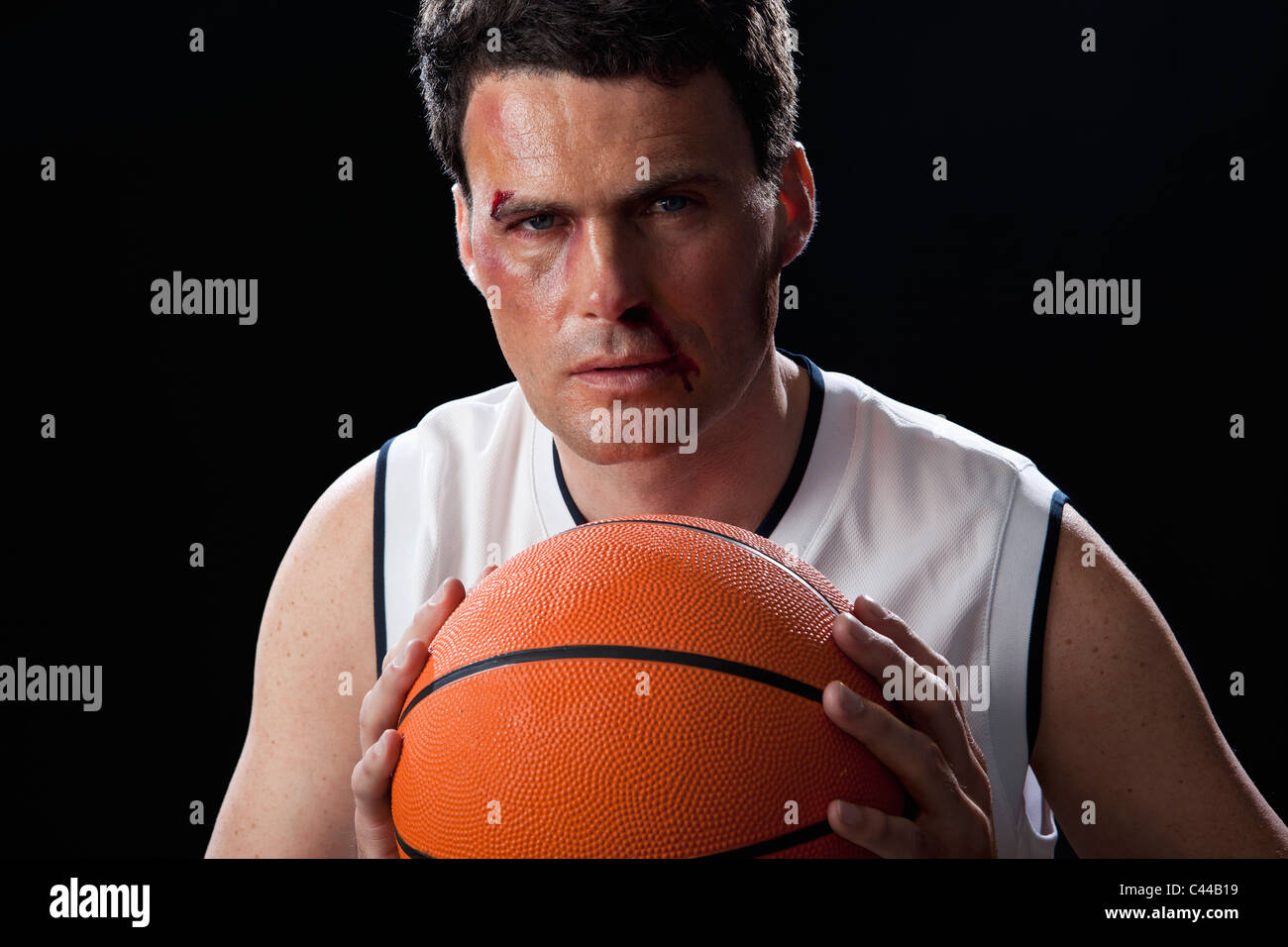 A bruised basketball player preparing to a pass the ball Stock Photo