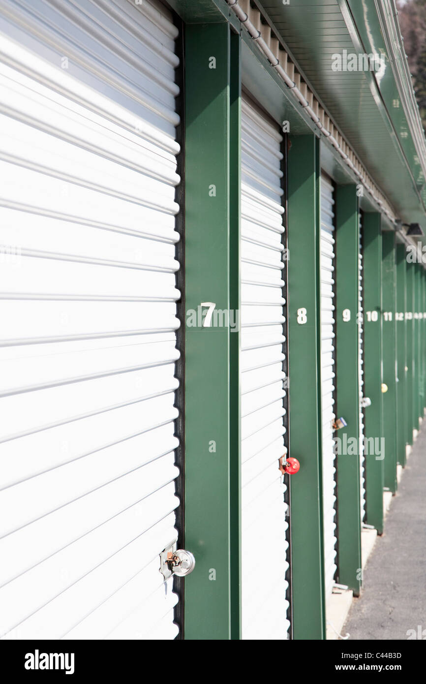 A row of locked storage units at a self storage facility Stock Photo