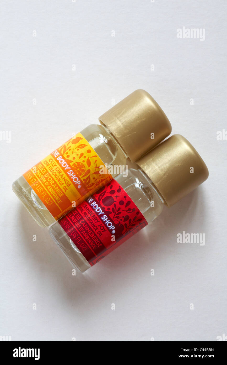 Two bottles of The Body Shop home fragrance oil - one jolly orange and one cranberry joy isolated on white background Stock Photo