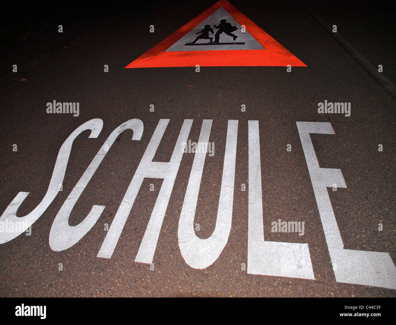 Evening, dark, school, street, road sign, warning, Switzerland, writing, traffic Stock Photo