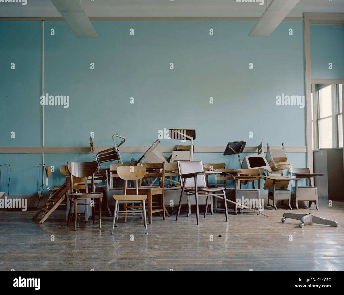 Old, broken chairs in an abandoned school Stock Photo