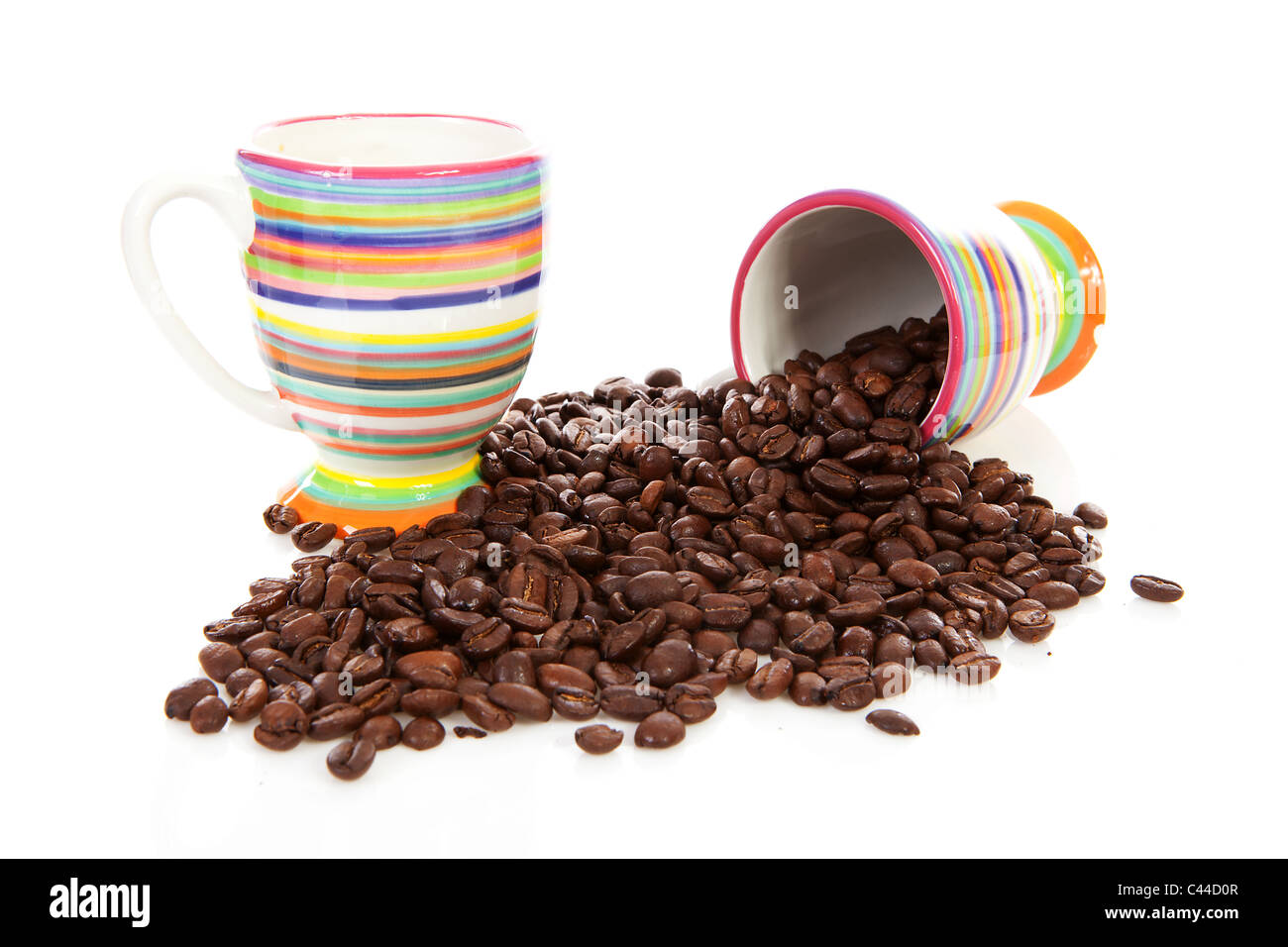 Coffee cups and pile of of roasted beans over white background Stock ...
