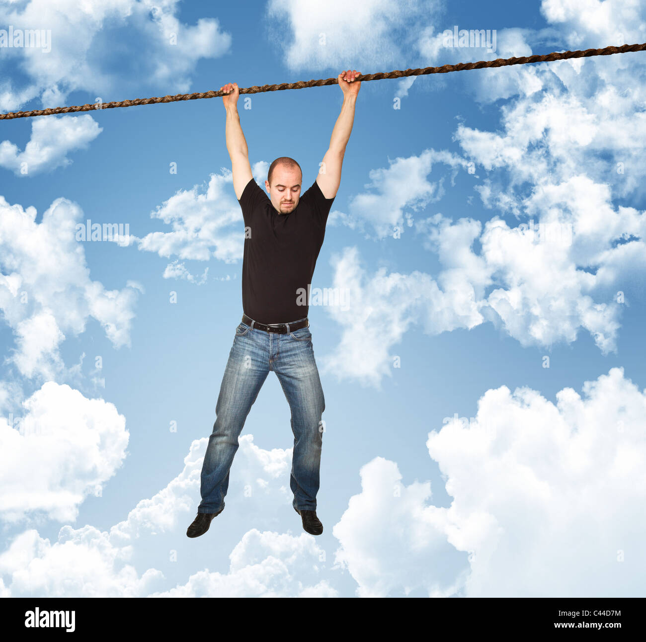 man on rope with blue sky background Stock Photo
