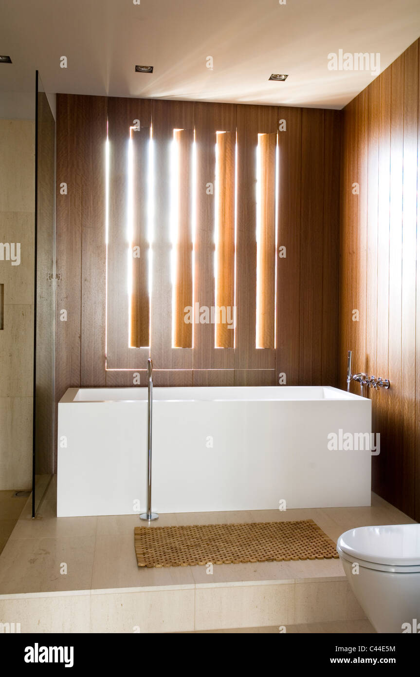 Minimal Modern Bathroom With Wooden Wall Panelling And Corian