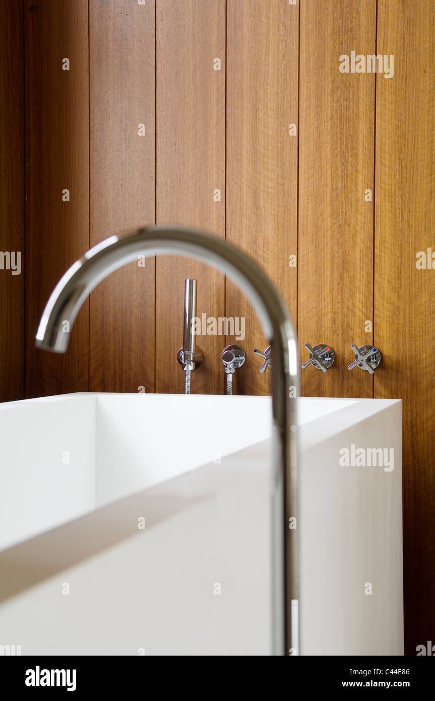 Corian bathtub with taps set in to the wall panelling Stock Photo