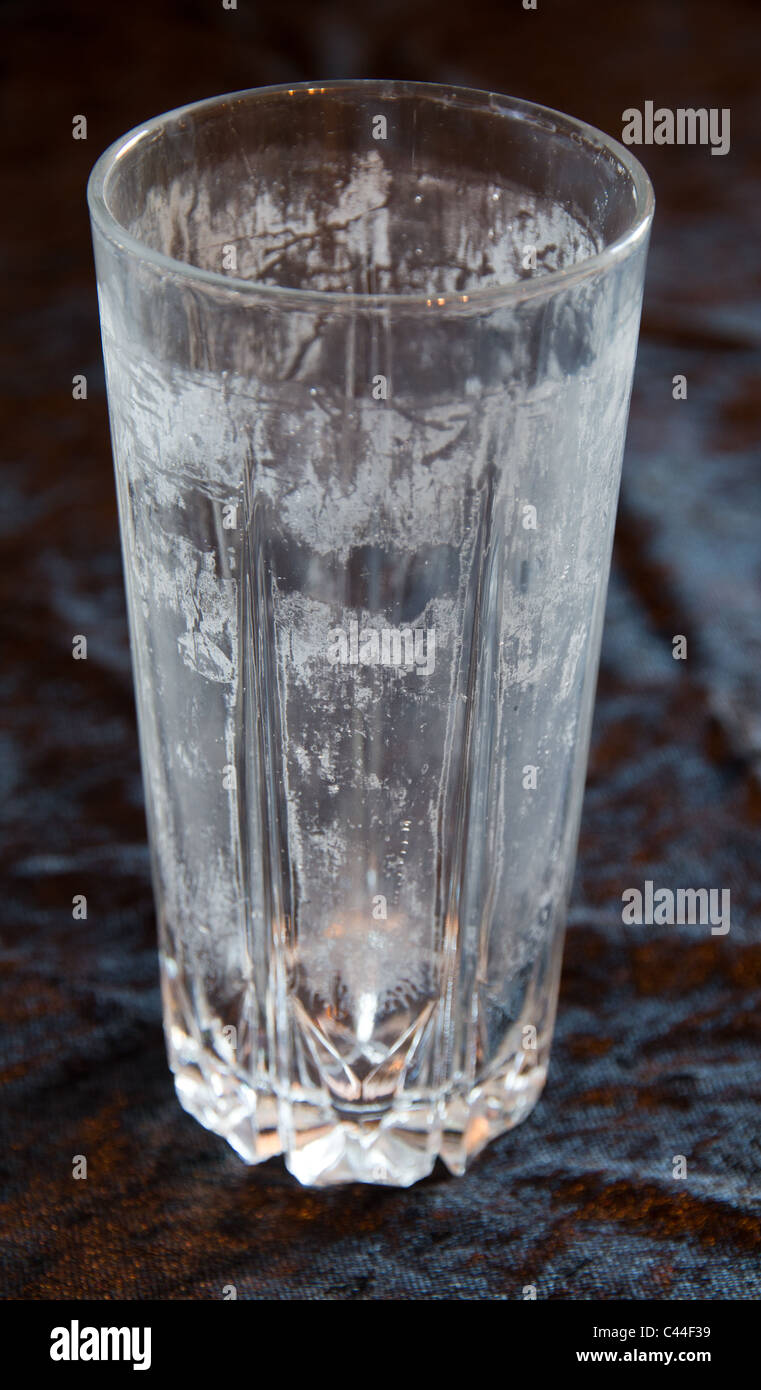 Drinking glass showing lime scale damage Stock Photo Alamy