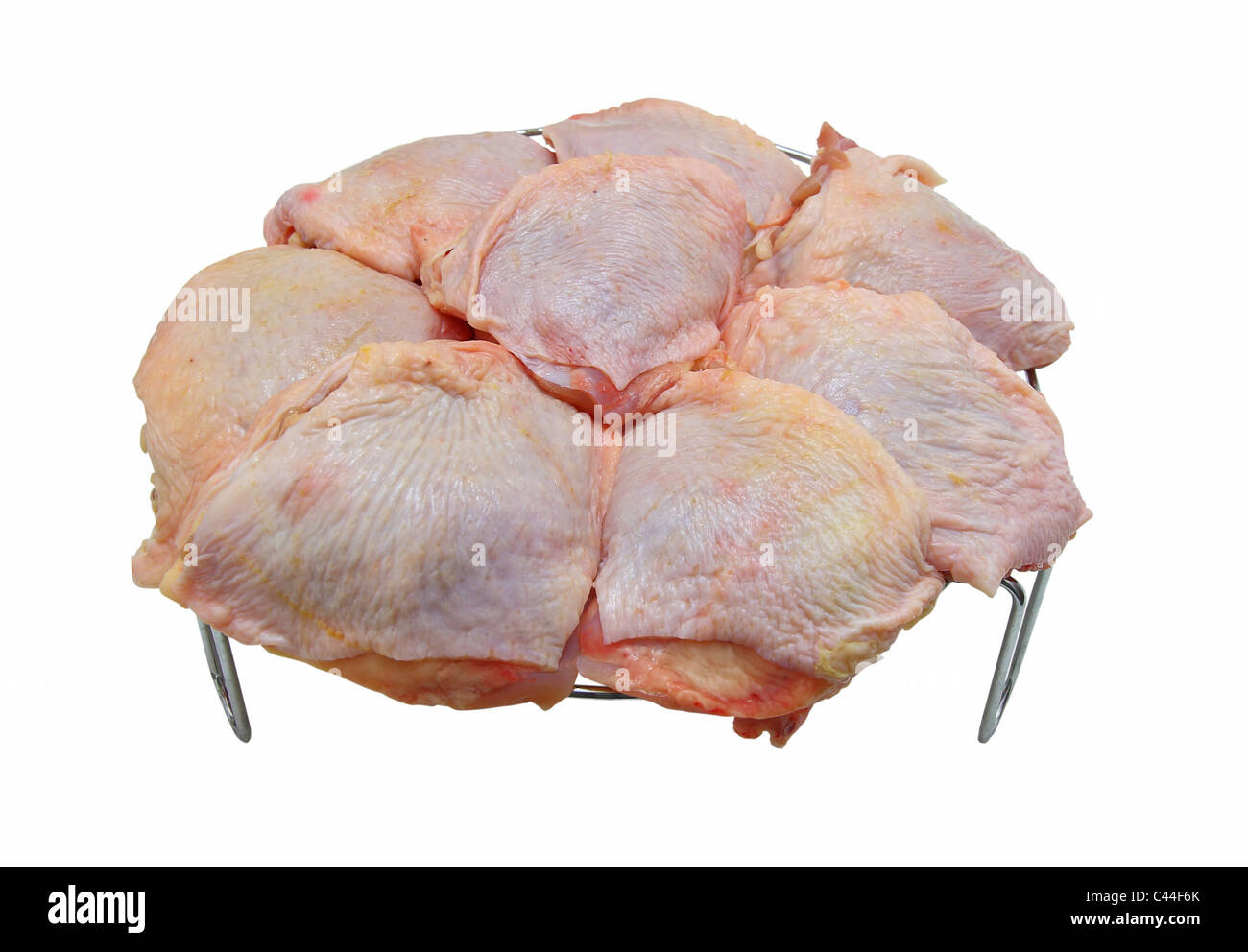 Chicken gammons lie on a metal lattice for a frying Stock Photo