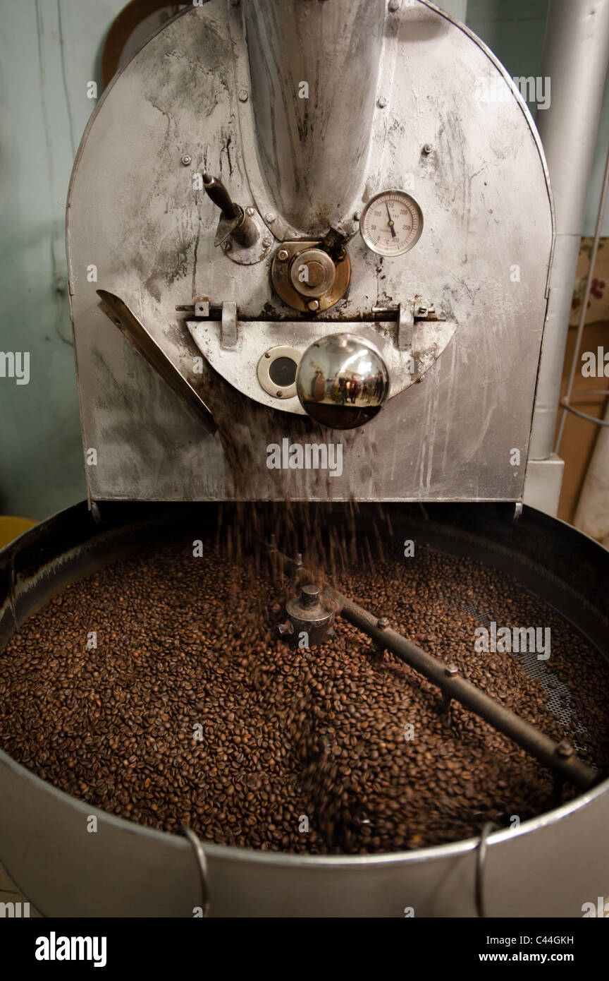 The arms of a coffee roasting machine turn to help the beans roast
