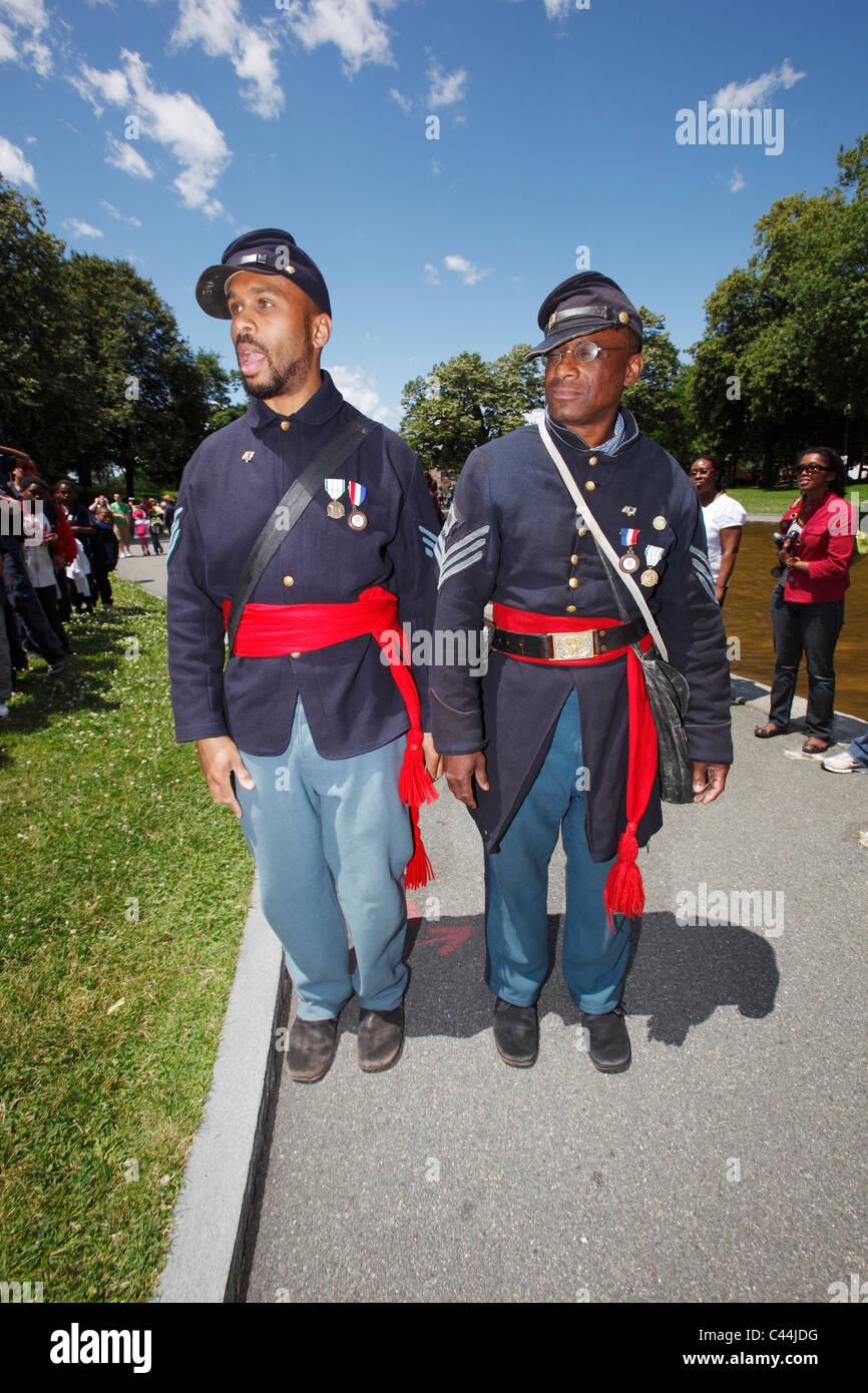 Reenactors in the uniform of the 54th Massachusetts Volunteer Infantry Regiment, an all black unit in the American Civil War Stock Photo