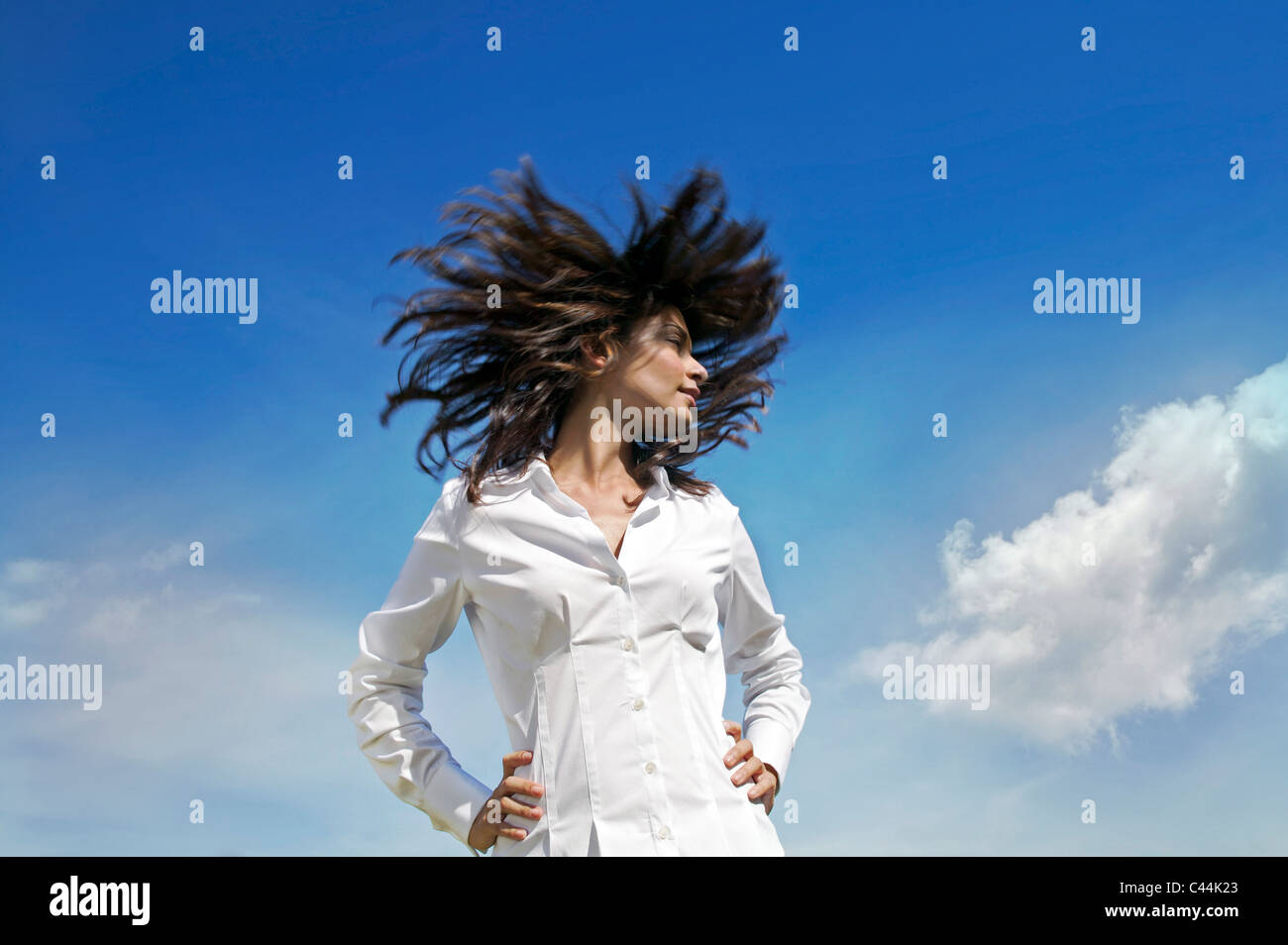 woman flips her hair in the sky Stock Photo Alamy