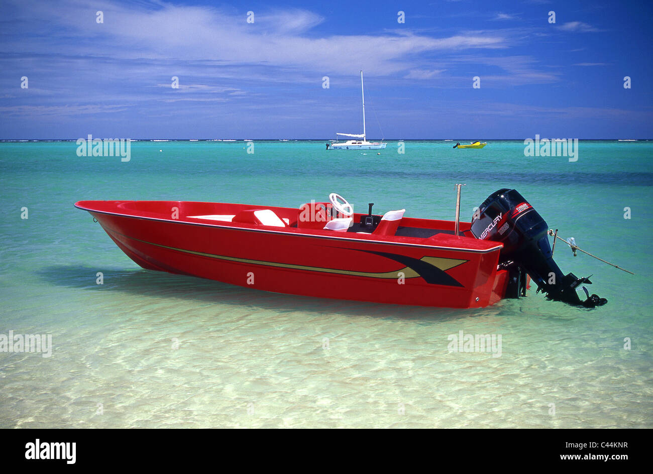 Bright Red Speedboat moored on beach in Mauritius, Indian Ocean Stock Photo