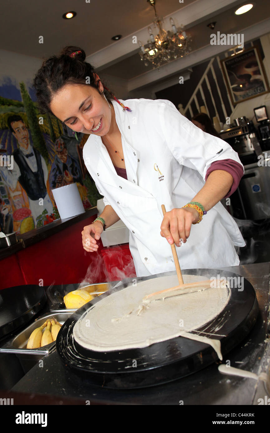 A nice young girl preparing a pancake savory crepe in a shop in Brighton, East Sussex, UK. Stock Photo