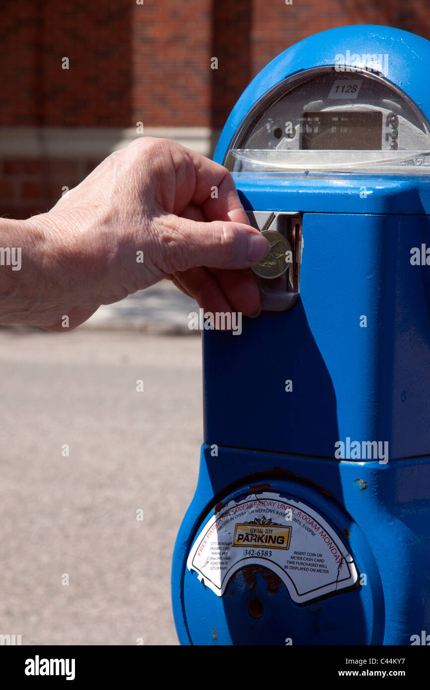 Person depositing money in parking meter USA Stock Photo Alamy