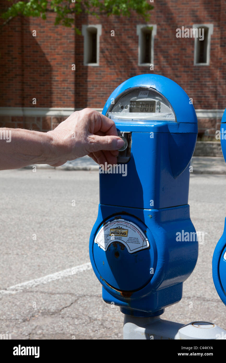Person depositing money in parking meter USA Stock Photo Alamy