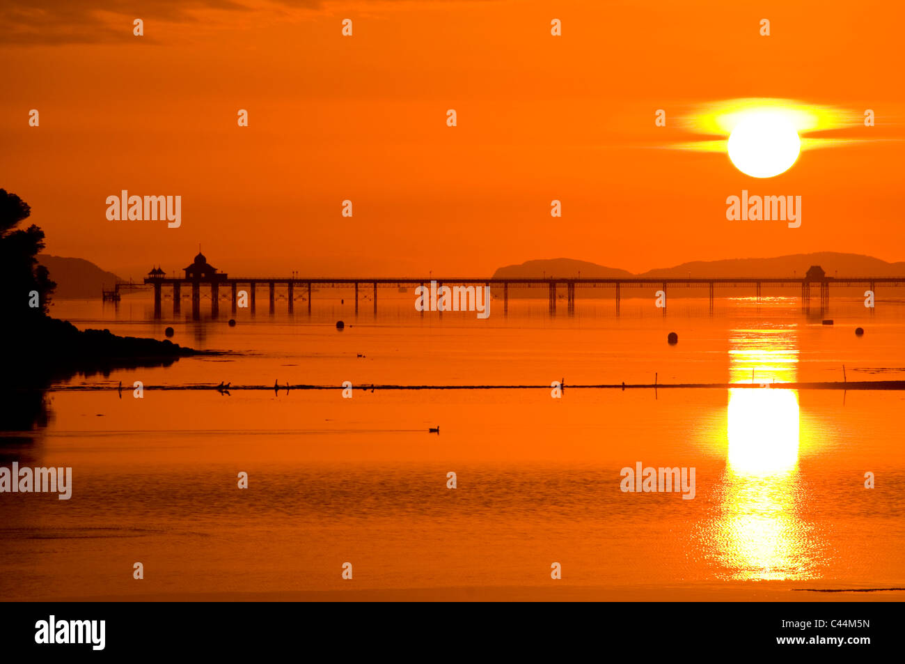 Bangor Pier, The Menai Straits & Great Orme Headland at Sunrise, Anglesey, North Wales, UK Stock Photo